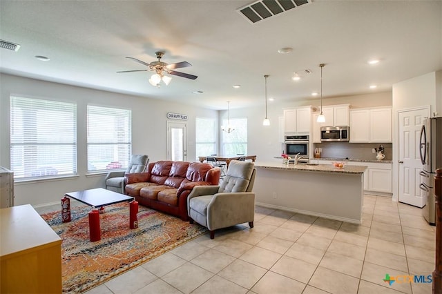 2502 Dante Ct, Harker Heights, TX 76548 - living area with light tile patterned floors, healthy amount of natural light, ceiling fan, and recessed lighting