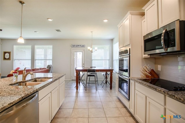 2502 Dante Ct, Harker Heights, TX 76548 - kitchen with stainless steel appliances, tasteful backsplash, hanging light fixtures, light stone counters, and recessed lighting
