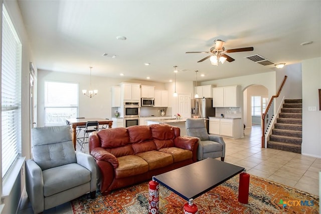2502 Dante Ct, Harker Heights, TX 76548 - living room with healthy amount of natural light, light tile patterned floors, arched walkways, and ceiling fan