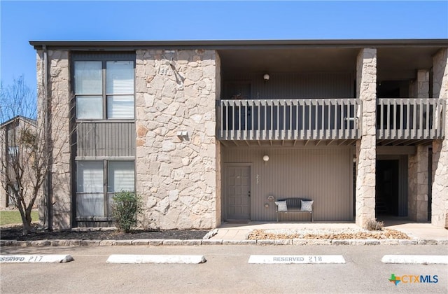 view of property with uncovered parking