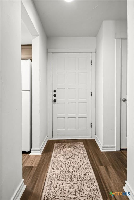 entrance foyer featuring baseboards and wood finished floors