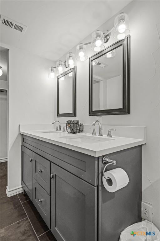 full bathroom featuring a sink, visible vents, and double vanity