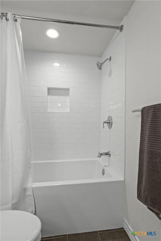 full bathroom with tile patterned flooring, toilet, and shower / bath combo with shower curtain