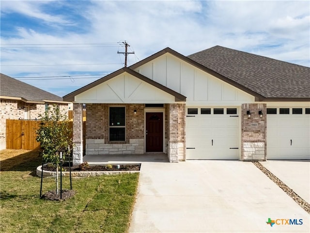 view of front of home featuring a porch, a front yard, and a garage