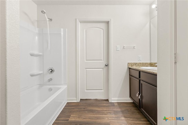 bathroom featuring shower / bathing tub combination, hardwood / wood-style floors, and vanity