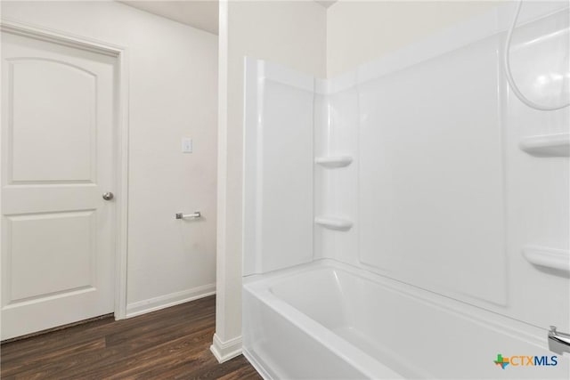 bathroom with hardwood / wood-style floors and shower / bathtub combination