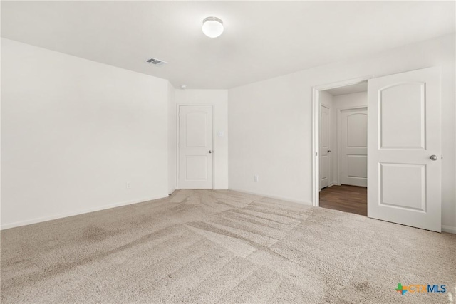 unfurnished room featuring carpet