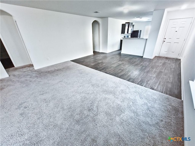 unfurnished living room featuring dark hardwood / wood-style floors