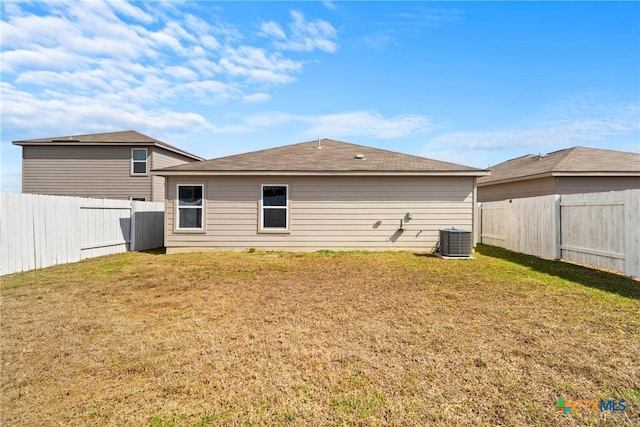 back of property featuring a yard and central air condition unit