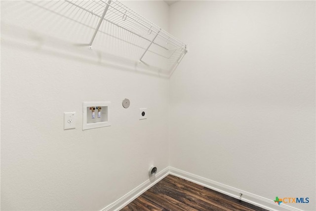 clothes washing area with dark wood-type flooring, hookup for an electric dryer, hookup for a gas dryer, and hookup for a washing machine