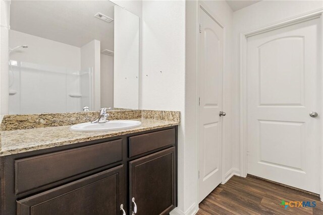 bathroom with hardwood / wood-style flooring and vanity