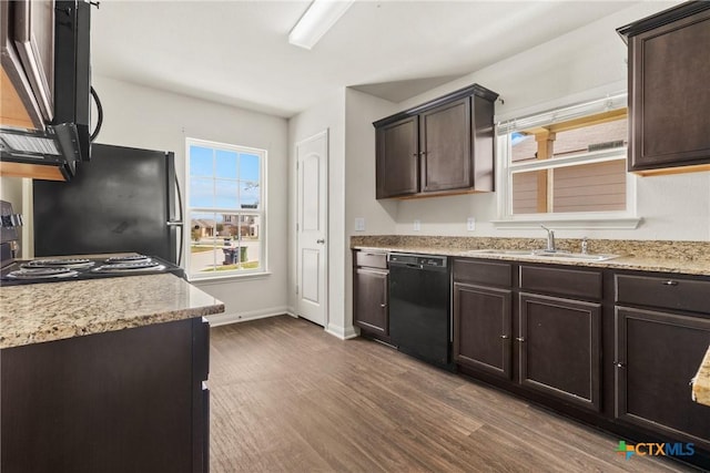 kitchen featuring sink, dark brown cabinets, dark hardwood / wood-style floors, dishwasher, and stove