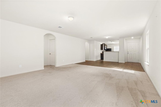 unfurnished living room featuring carpet