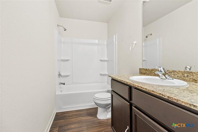 full bathroom with vanity, hardwood / wood-style floors, bathtub / shower combination, and toilet