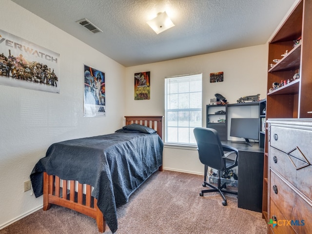 carpeted bedroom with a textured ceiling