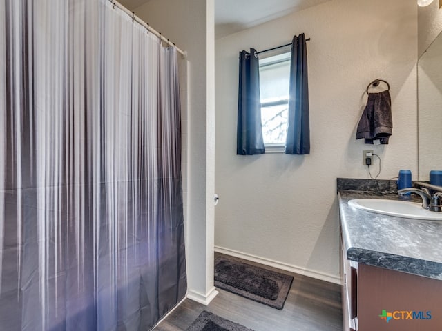 bathroom featuring vanity, hardwood / wood-style floors, and curtained shower