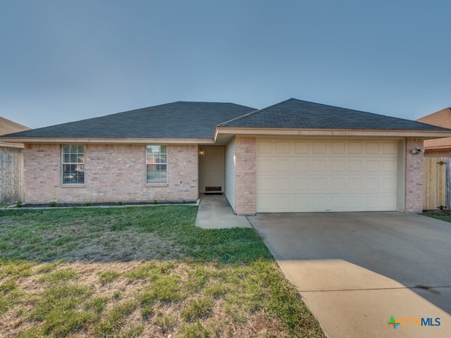 single story home with a garage and a front yard