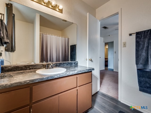 bathroom featuring hardwood / wood-style floors and vanity