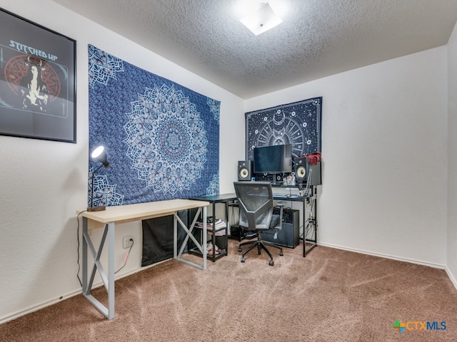 carpeted office space featuring a textured ceiling