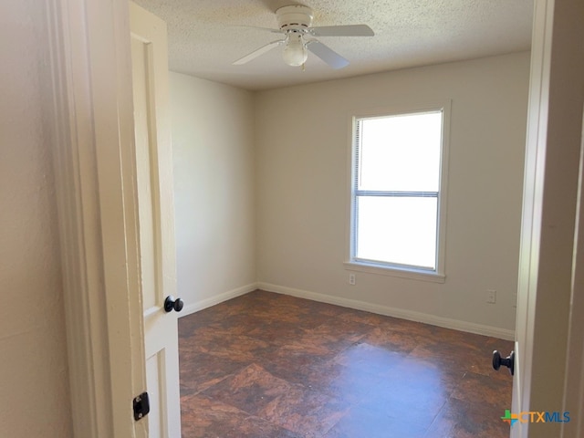 spare room featuring a textured ceiling and ceiling fan