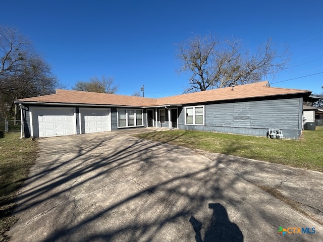 single story home featuring a garage and a front yard