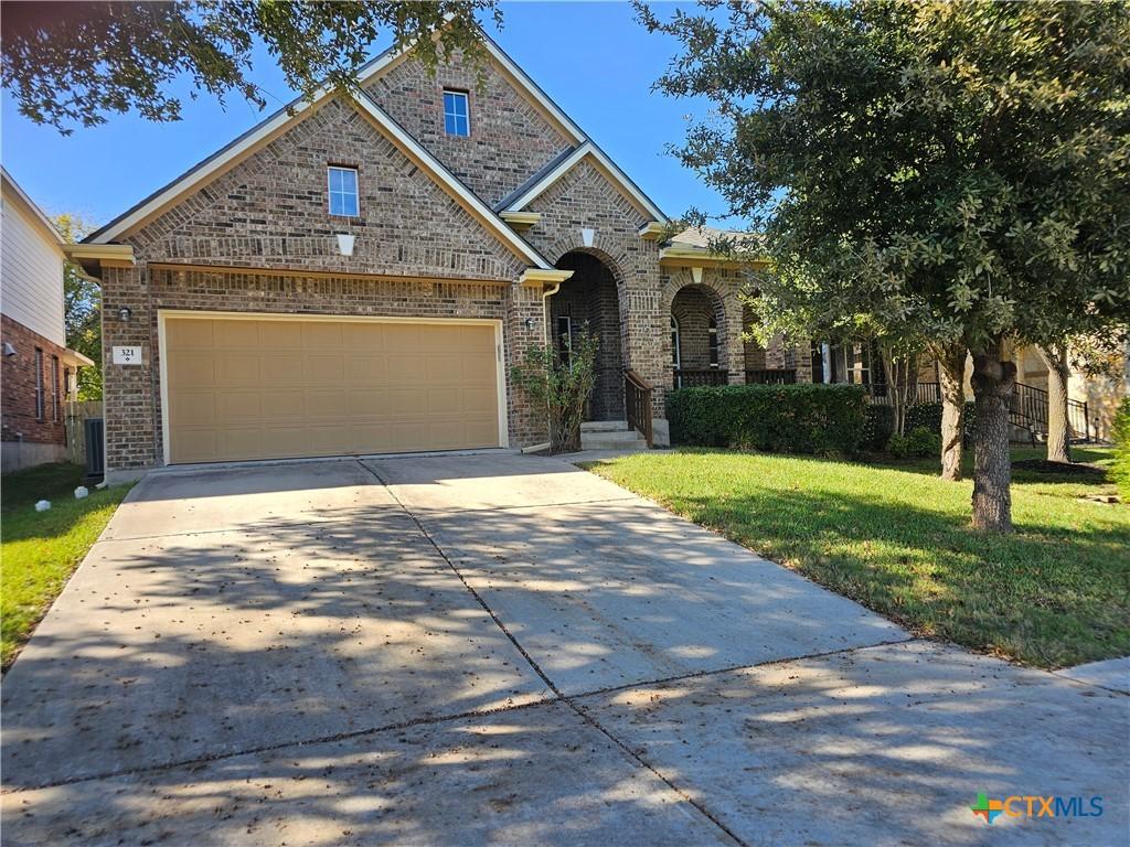 view of front of property featuring a garage and a front lawn