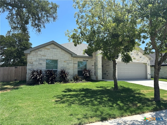 view of front of home with a garage and a front yard