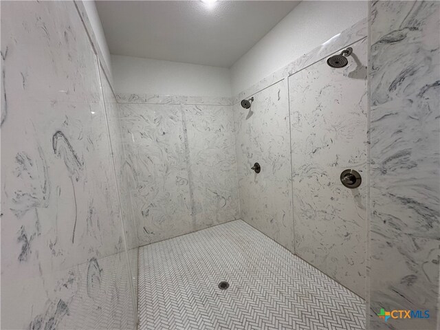 bathroom with a tile shower