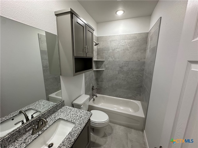 full bathroom featuring vanity, tiled shower / bath combo, and toilet