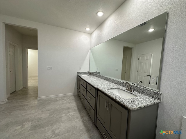 bathroom featuring vanity and a textured ceiling