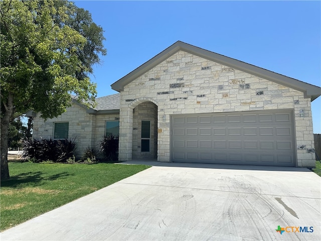 view of front of house with a garage and a front yard