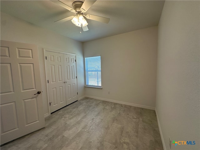 unfurnished bedroom featuring light hardwood / wood-style floors, ceiling fan, and a closet