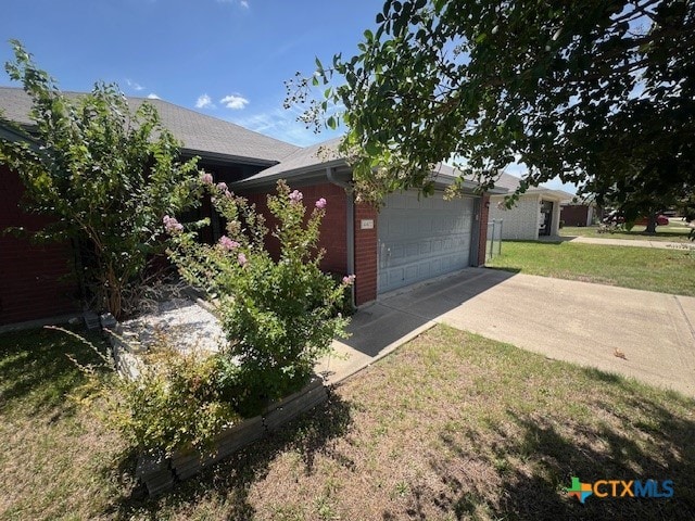 view of front of property with a front lawn and a garage