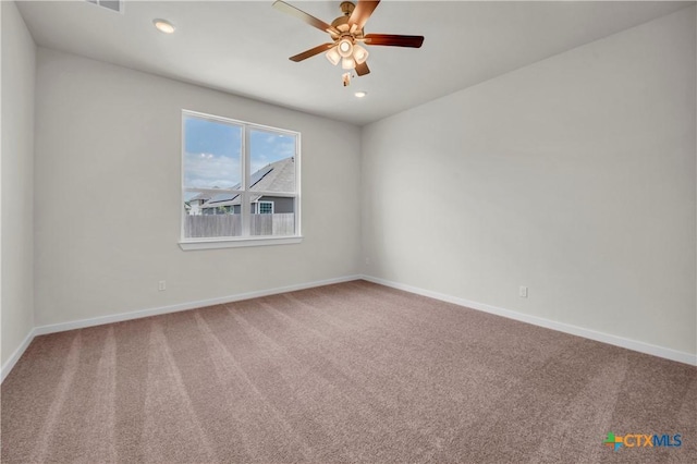 carpeted spare room featuring ceiling fan, baseboards, and recessed lighting