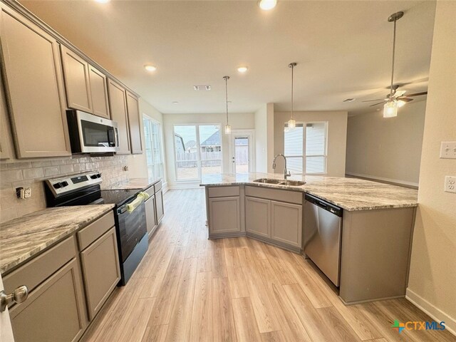 unfurnished living room with dark hardwood / wood-style flooring, a healthy amount of sunlight, and ceiling fan