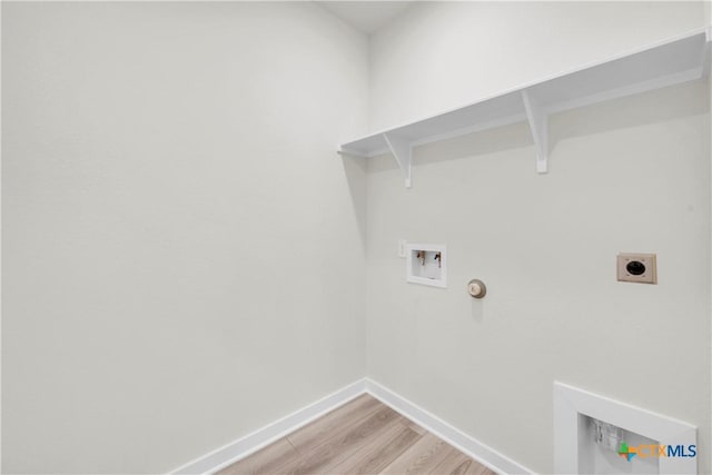 clothes washing area with light wood-style flooring, baseboards, hookup for a washing machine, electric dryer hookup, and laundry area