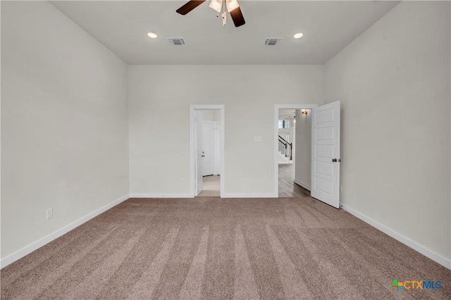unfurnished bedroom featuring carpet, visible vents, and baseboards