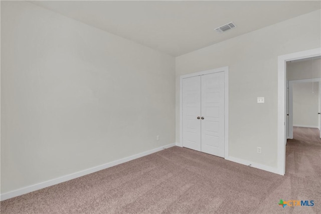 unfurnished bedroom featuring visible vents, baseboards, and carpet flooring
