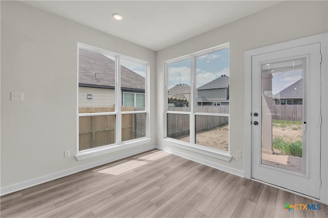 interior space featuring baseboards, wood finished floors, and recessed lighting