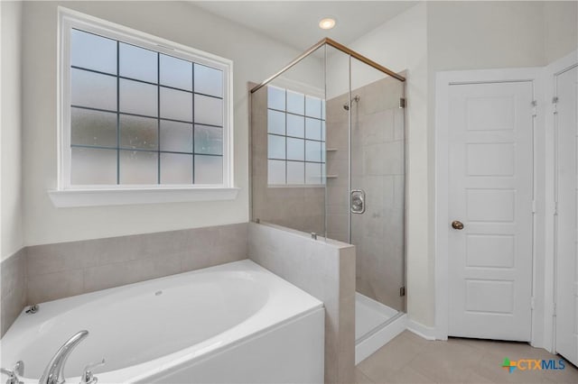 full bathroom with a shower stall, a bath, and tile patterned flooring