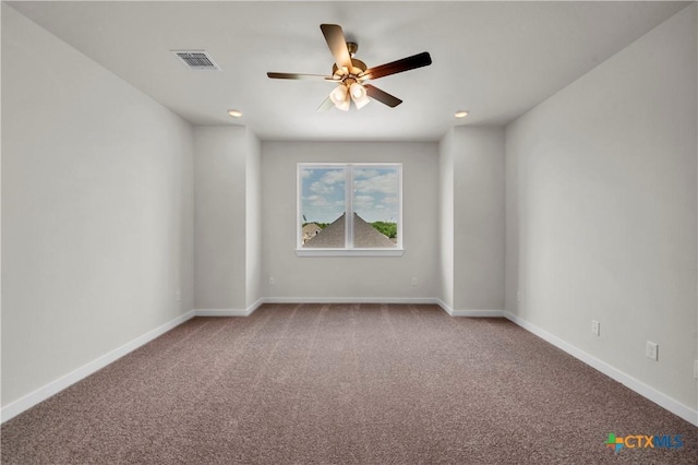 empty room featuring baseboards, a ceiling fan, visible vents, and carpet floors