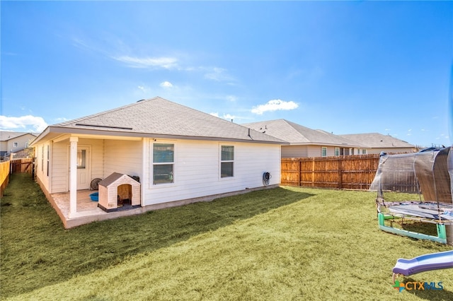 back of house with a patio and a yard