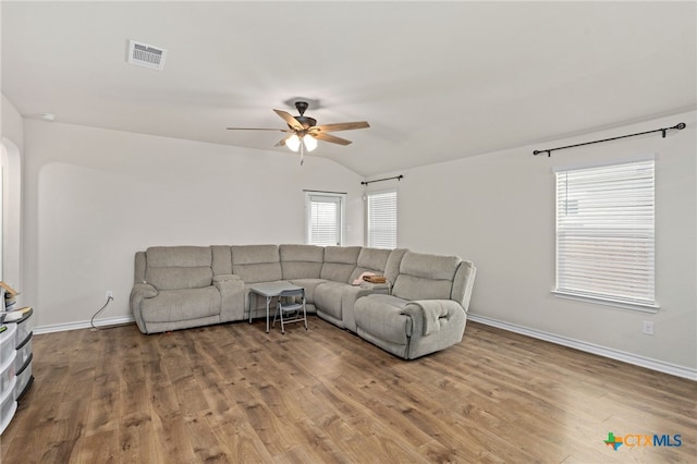 living room featuring lofted ceiling, hardwood / wood-style floors, and ceiling fan