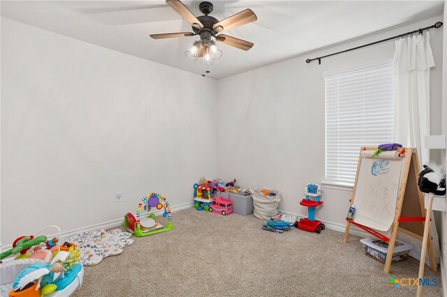 rec room featuring carpet flooring and ceiling fan