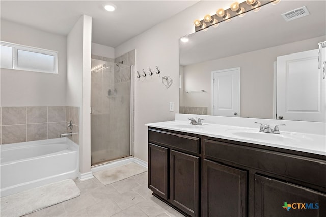 bathroom featuring independent shower and bath, vanity, and tile patterned floors