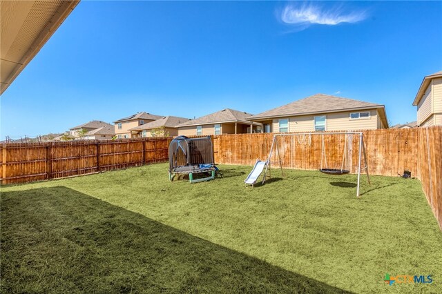 view of yard with a trampoline