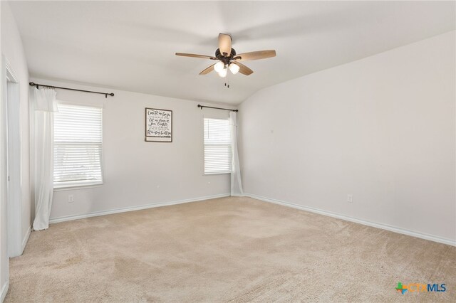 spare room with light colored carpet and ceiling fan