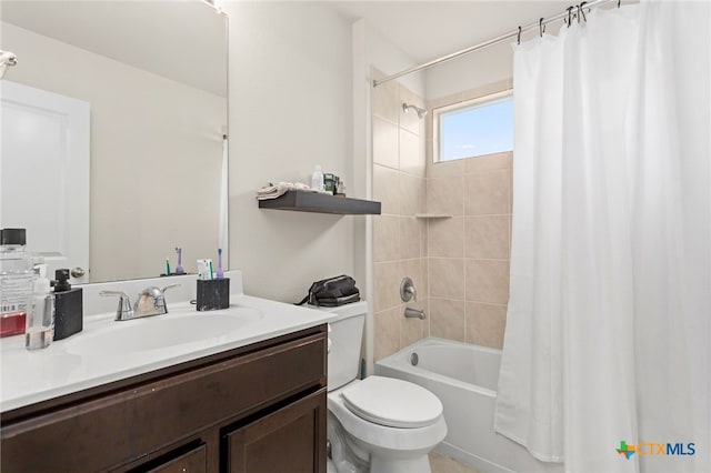 full bathroom featuring shower / tub combo with curtain, vanity, and toilet