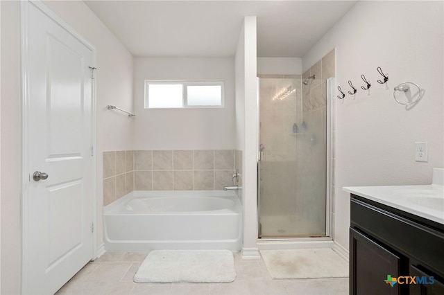 bathroom featuring tile patterned flooring, vanity, and separate shower and tub