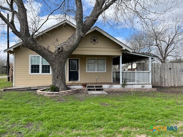 bungalow-style home with a front yard and a porch